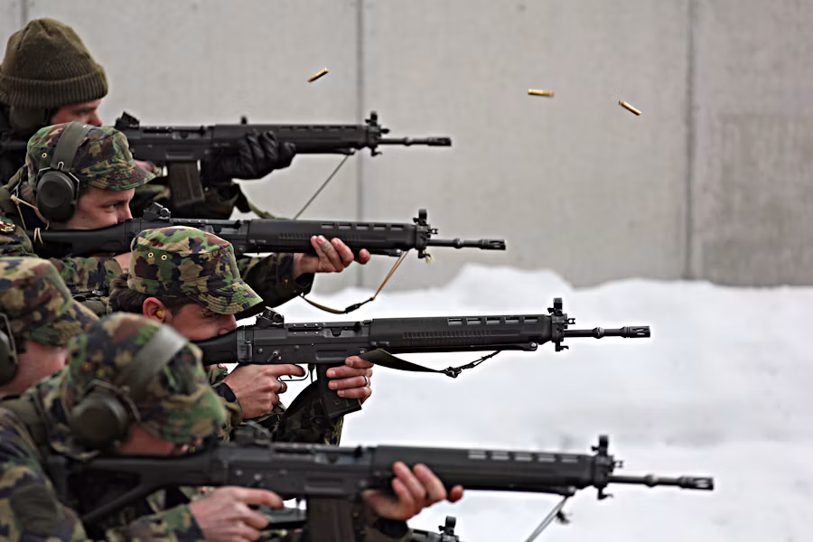 Soldiers conducting rifle target practice with ear protection